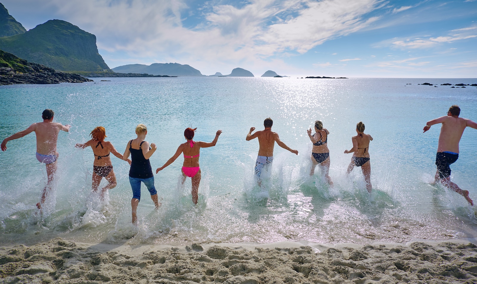 group of people playing on beach