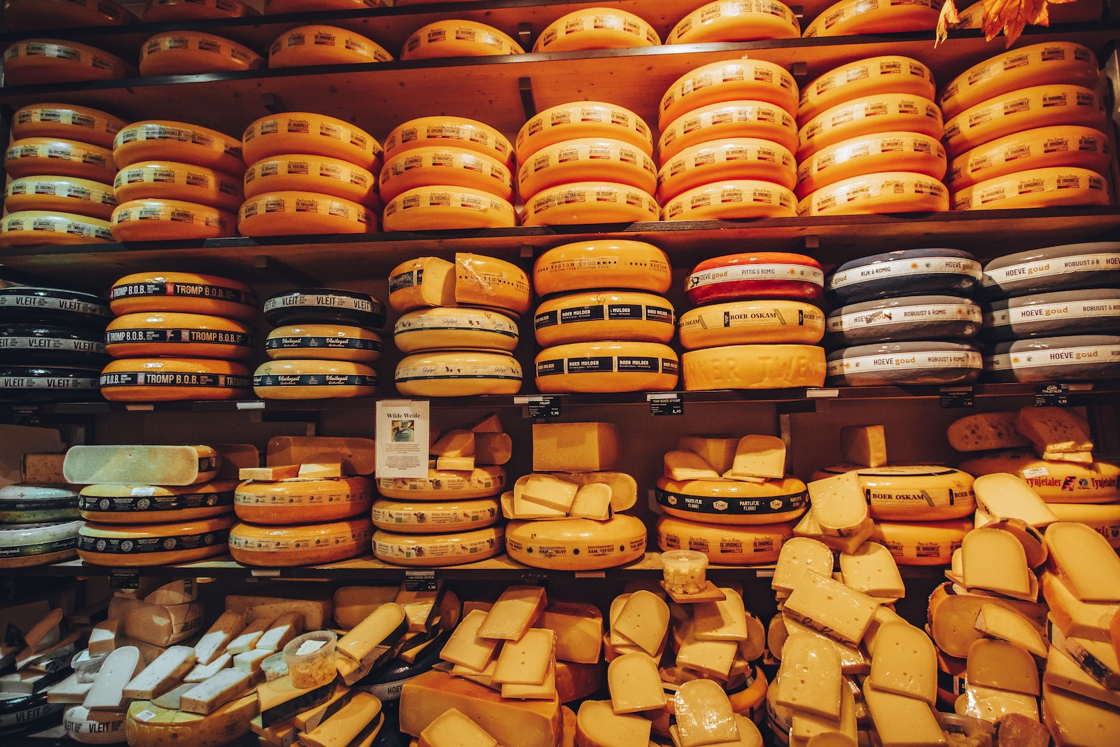 a shelf filled with lots of cheese covered in cheese