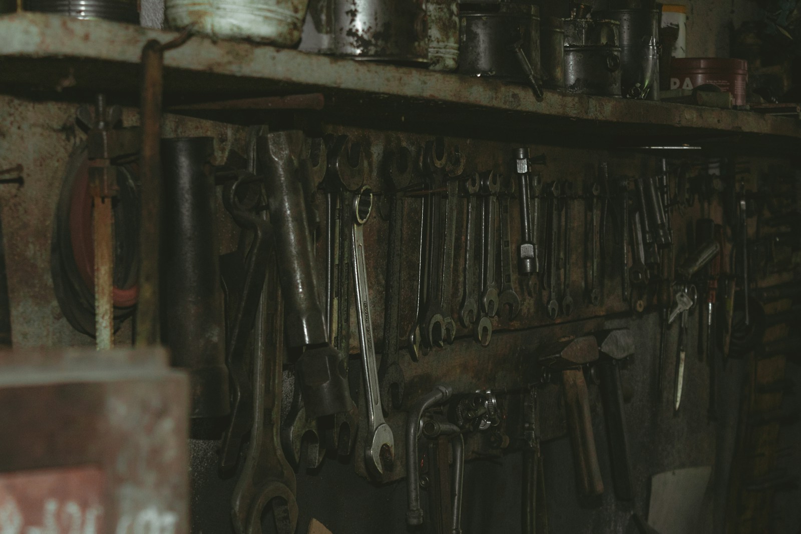 black metal tool on brown wooden shelf