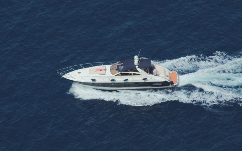 white and black speedboat on sea